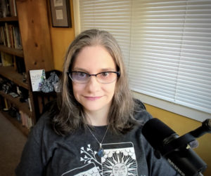 This is what you get when you ask me to talk on your show. I'm wearing a tarot themed shirt, with my glasses and have a professional mic. My book sits in the background.